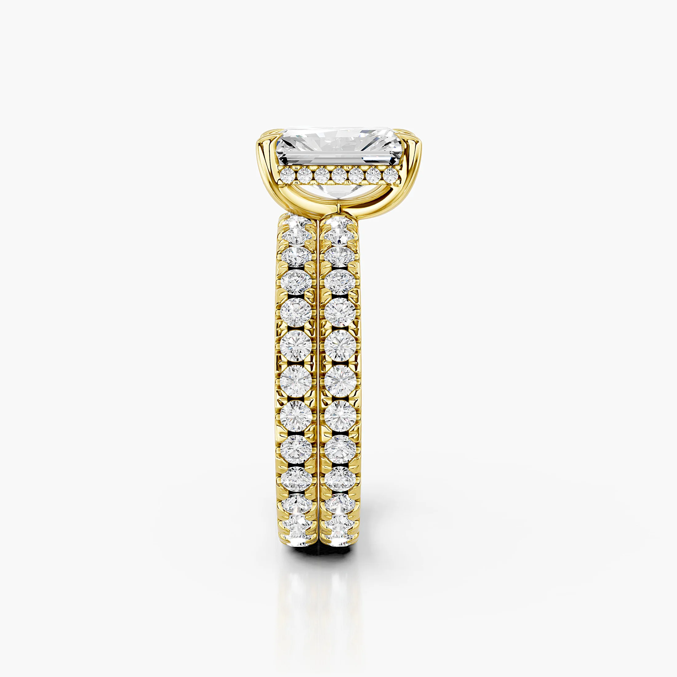 Radiant-cut hidden halo side-stone engagement ring with a coordinating straight diamond band shown as a two-piece bridal set